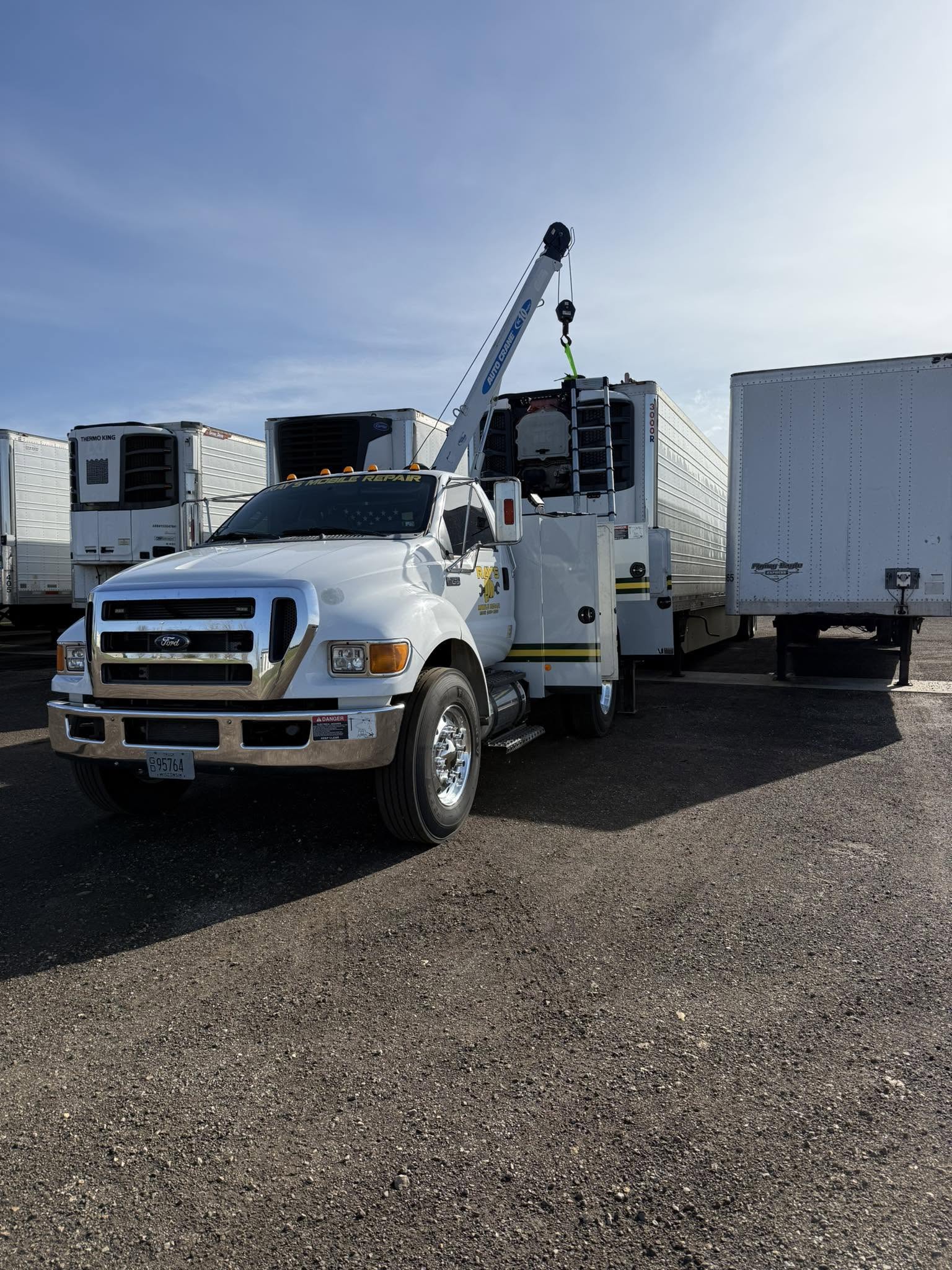 Ray's Mobile Repair crane truck servicing a trailer